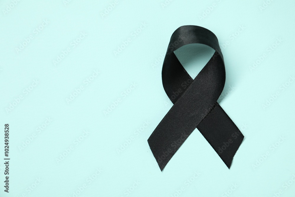 Poster Black awareness ribbon on light blue background, top view. Space for text