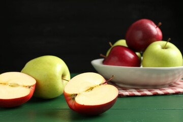 Fresh ripe apples on green wooden table