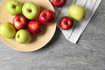 Fresh red and green apples on grey table, flat lay. Space for text