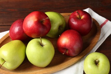 Fresh red and green apples on wooden table, closeup