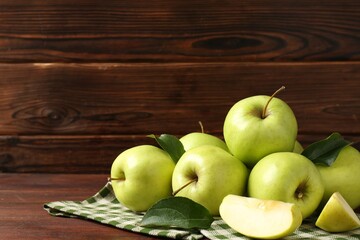 Fresh green apples on wooden table, space for text