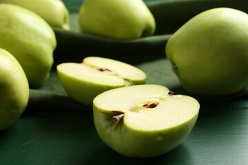 Ripe apples on green wooden table, closeup