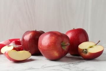 Ripe red apples on white marble table