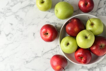 Ripe red and green apples on white marble table, top view. Space for text
