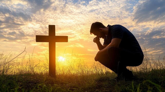 Man Praying at Cross with Sunset Silhouette Faith, Hope and Spirituality in Difficult Times.