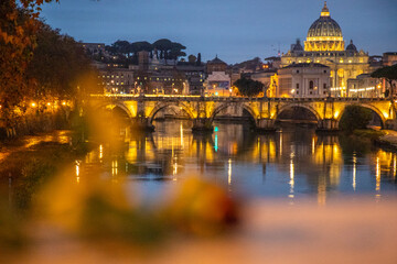 View over the Tiber River in a historic city. The old well-known bridge Ponte Sant'Angelo, in the...