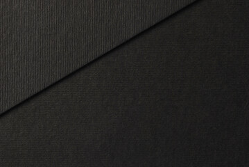 Black cardboard texture, a sheet of black cardboard above on another black cardboard