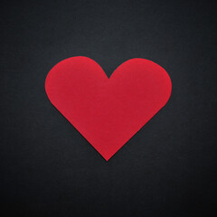 Obraz premium A red paper heart isolated on black background