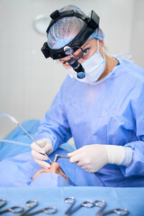 Professional surgeon performing surgery in modern operating room