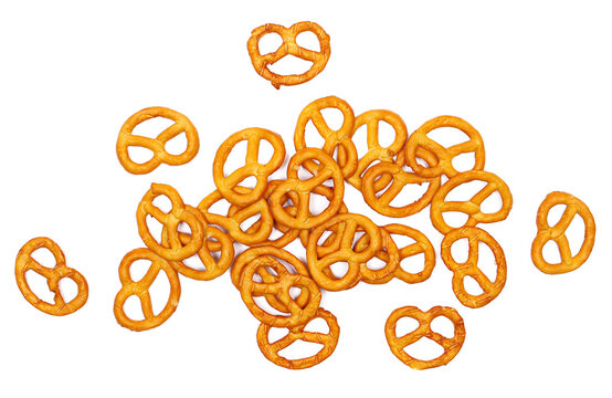 Salted pretzels pile, party snacks isolated on white, top view