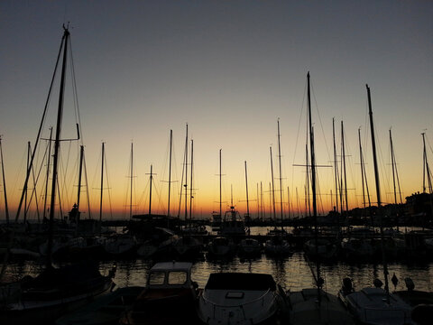 Yachts in the port at sunset, yachts in the harbor at sunset