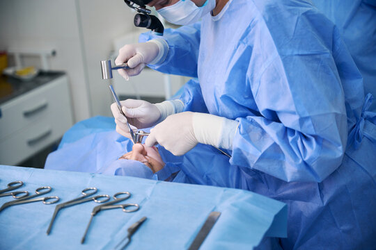 Surgical nurse assists a surgeon