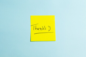 A yellow sticky note with the word "THANKS" written on it