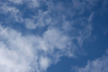 View of the sky with scattered white clouds. Concept of leisure, calm and peace