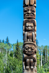 Canadian First Nations totem pole of the Gitxsan natives in Gitanyow or Kitwancool, British Columbia, Canada.