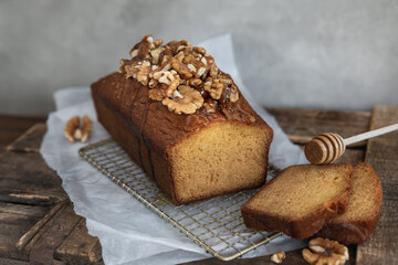 Sliced walnut and honey loaf cake on table