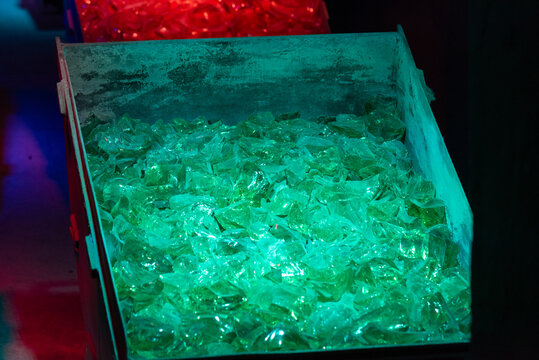 Container with bright green pieces of glass