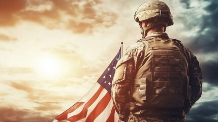 The powerful back view of an American soldier stands proudly with a waving flag against a bright sunny sky, embodying a strong military theme. Dressed in a military uniform and helmet, the soldier rep