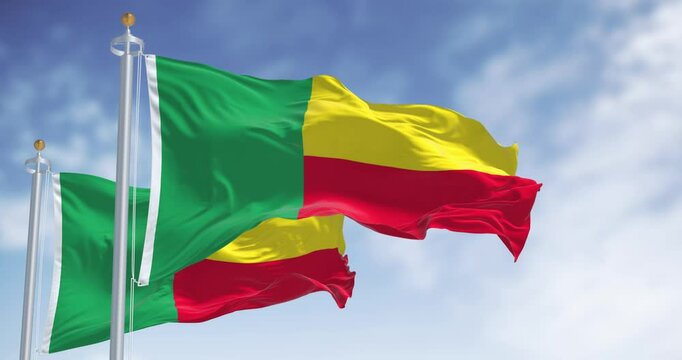 Two Benin national flags waving on a clear day