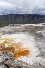 Geothermal Hot Spring Landscape in Yellowstone National Park, Wyoming, USA Under a Dramatic Cloudy Sky