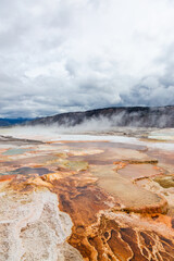 Scenic View of Geothermal Hot Springs in Yellowstone National Park, Wyoming Amidst Majestic Natural Landscapes