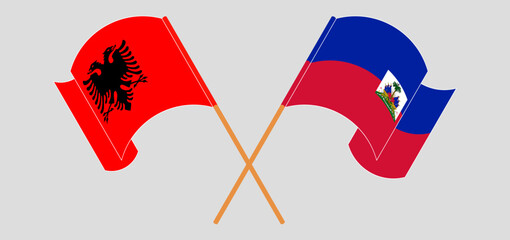Crossed and waving flags of Albania and Republic of Haiti. Vector illustration