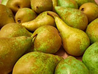 Pile of green pears on wooden table