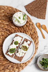 Homemade crispy toasts with ricotta, cottage cheese and herbs, 
microgreens, healthy eating, food for athletes