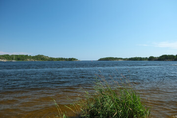 panorama of the lake and green grass in the foreground