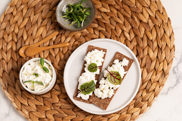 Homemade crispy toasts with ricotta, cottage cheese and herbs, 
microgreens, healthy eating, food for athletes