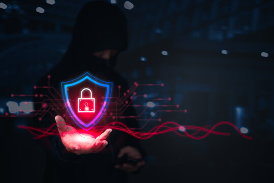A hacker holds a glowing shield with a digital lock, representing cyber protection or breach.