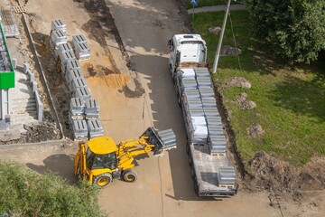 Top view of construction site with truck and loader