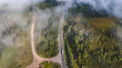 A truck and cars are driving along a beautiful road