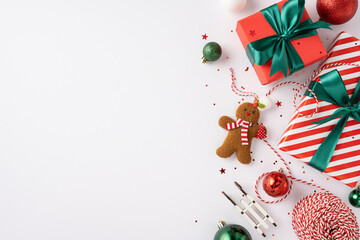 Christmas presents with green bows, gingerbread cookie, ornaments, and festive decorations on a white background conveying holiday cheer