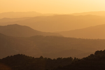 Beautiful sunset in the mountains. Mountain layers. Orange sky. Near Stavrovouni Monastery in Cyprus