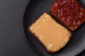 Sandwiches with toast bread, peanut butter and raspberry or strawberry jam
