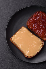 Sandwiches with toast bread, peanut butter and raspberry or strawberry jam