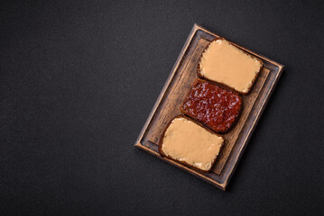 Sandwiches with toast bread, peanut butter and raspberry or strawberry jam