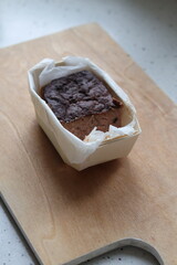 A minimalist photo of homemade pork pate with cranberries in a small tin