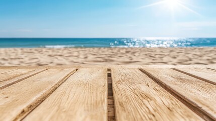 Fototapeta premium Close-up of a wooden deck overlooking a serene beach with calm waves and a bright blue sky on a sunny day.