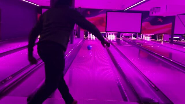 Enthusiast people playing indoor bowling in game zone. Copyspace 4K video of Background gaming zone. Entertainment hobby team game. 