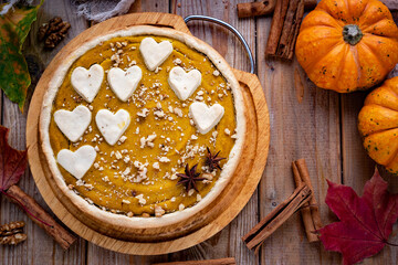 Delicious pumpkin pie on a wooden table. Pumpkin dessert. American pumpkin pie. close-up