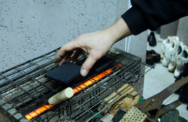 Shoemaker repairing shoes. Workshop.Selective focus.