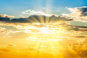 Sunset sky background with sun and sunset clouds