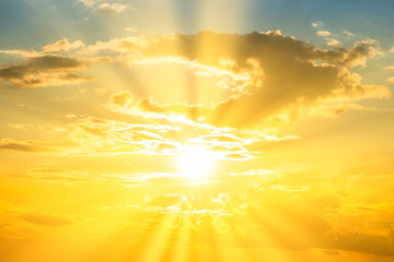Sunset sky background with sun and sunset clouds