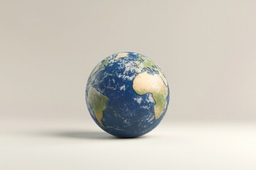 Fototapeta premium A blue and white globe on a white surface