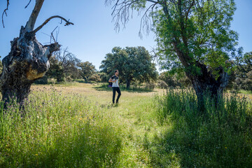 Solo traveler walking along a forest trail with a backpack