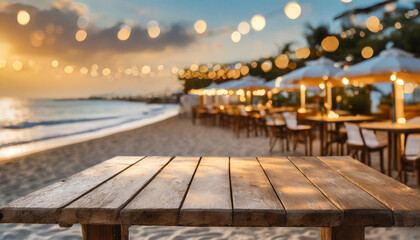 Cozy beachside dining with string lights illuminating tables during sunset near the shoreline