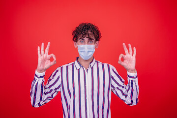 Naklejka premium Young attractive guy and cold. Red background.