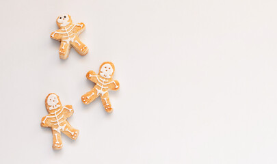 Halloween gingerbread cookies human shape on white background. Bright homemade cookies for Halloween party